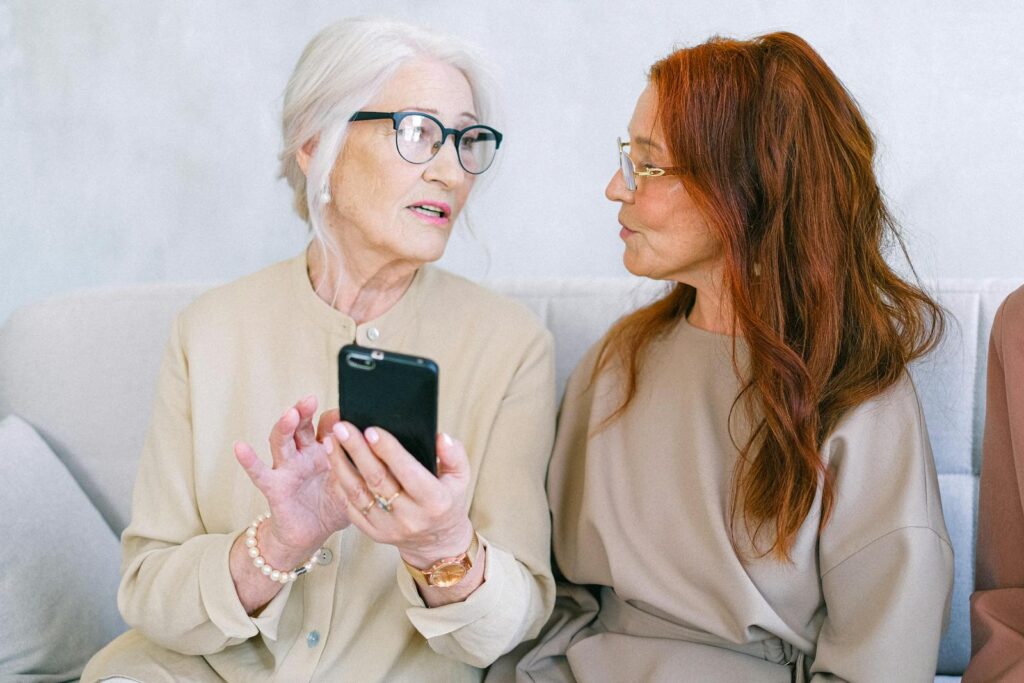 Elderly women sitting on sofa and communicating