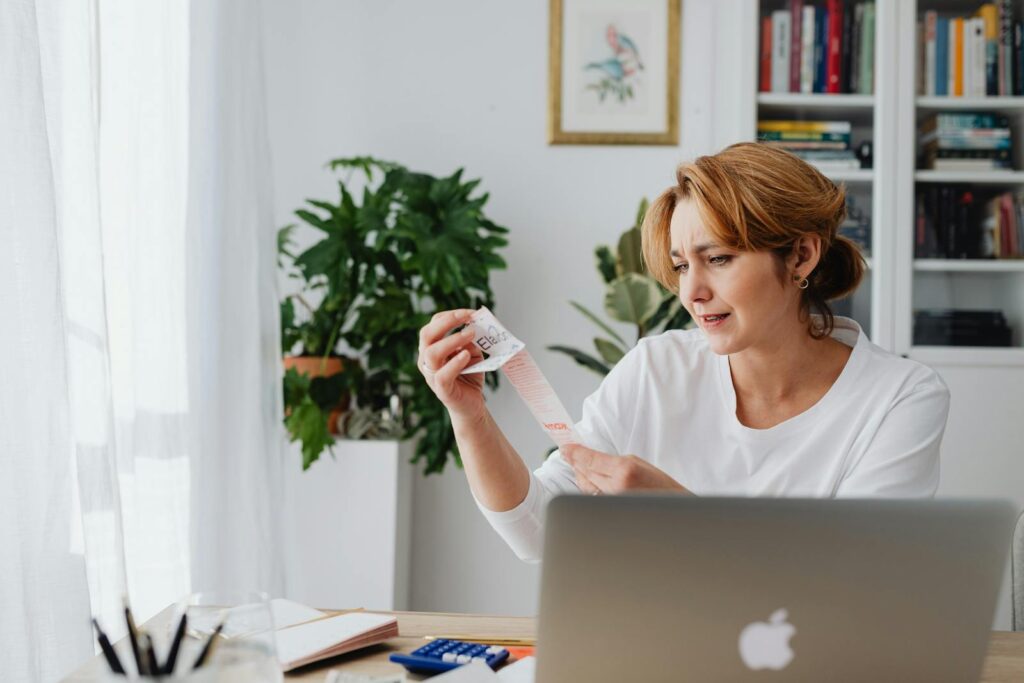 Woman Looking at Items on a Receipt 