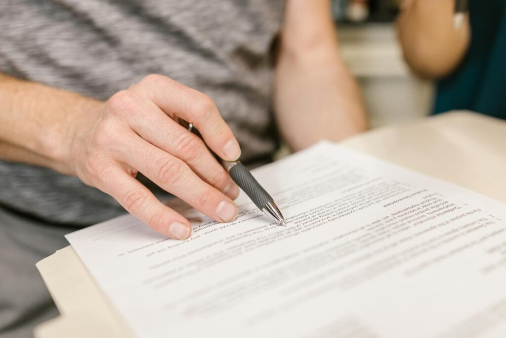 Person signing divorce paper