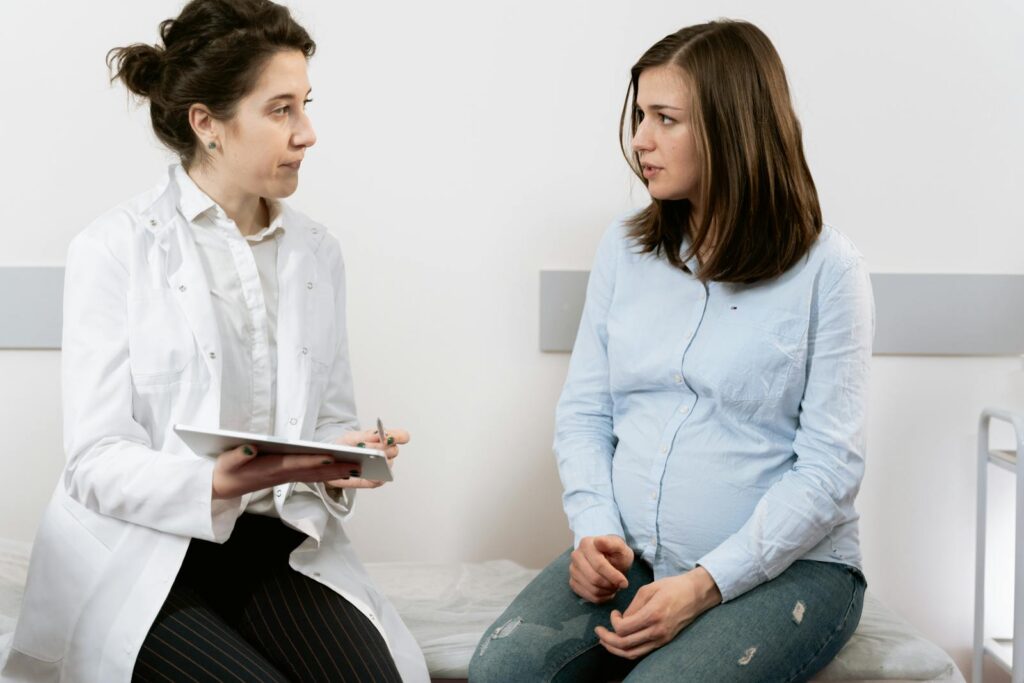 Pregnant woman talking to the doctor