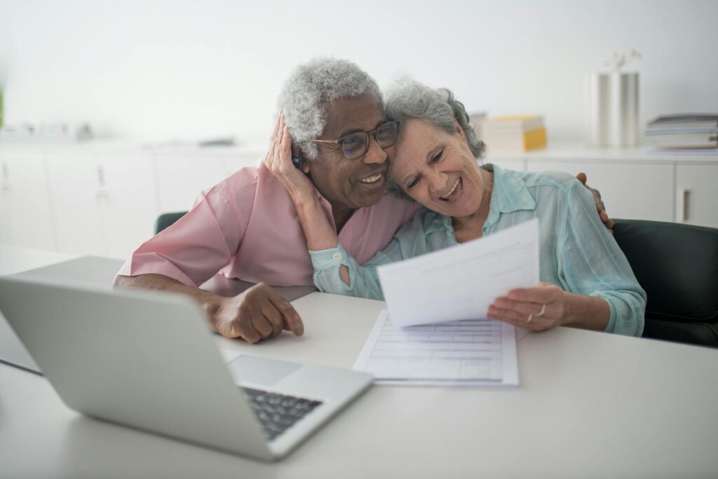 Happy elderly couple with a health insurance documents