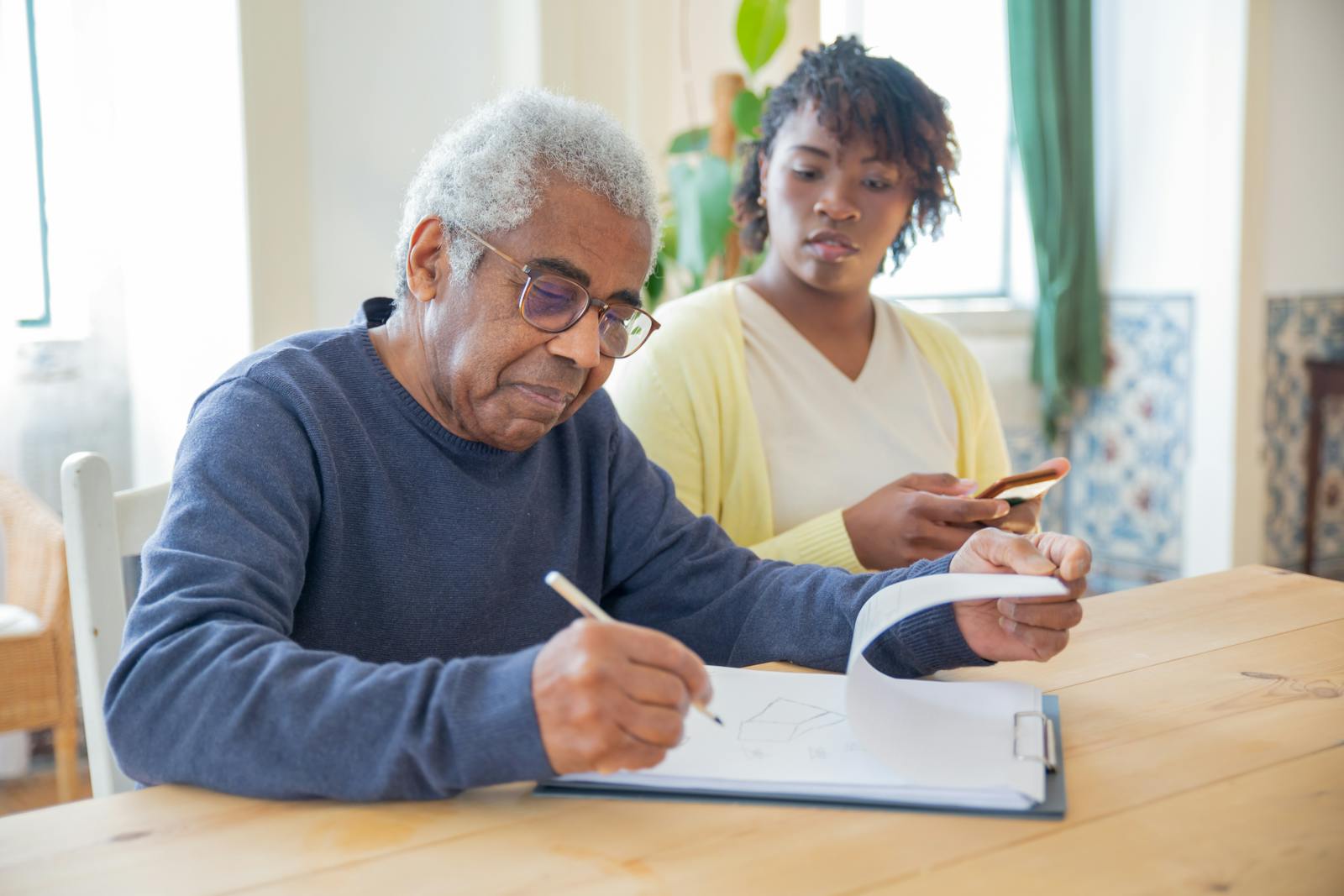 A Man in nursing home signing document