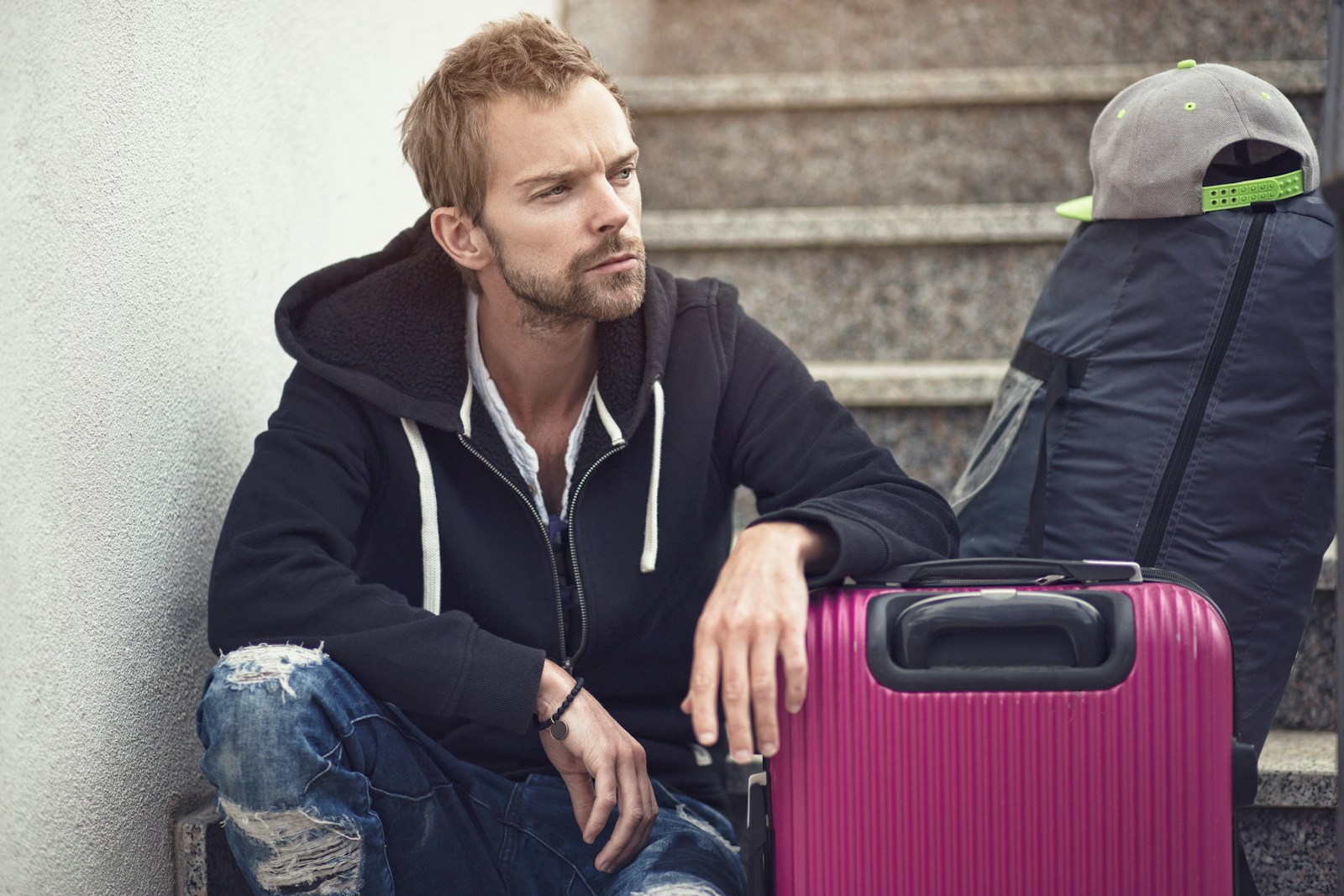 Man sitting with a suitcase