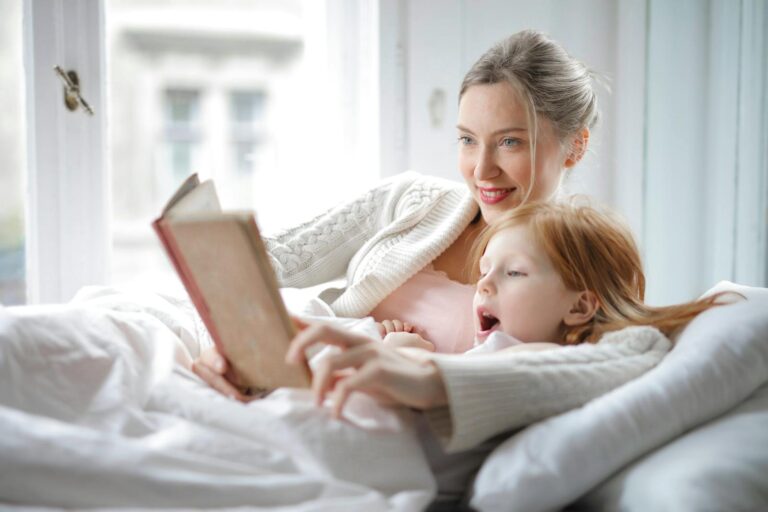 Woman hugging her child and reading book together