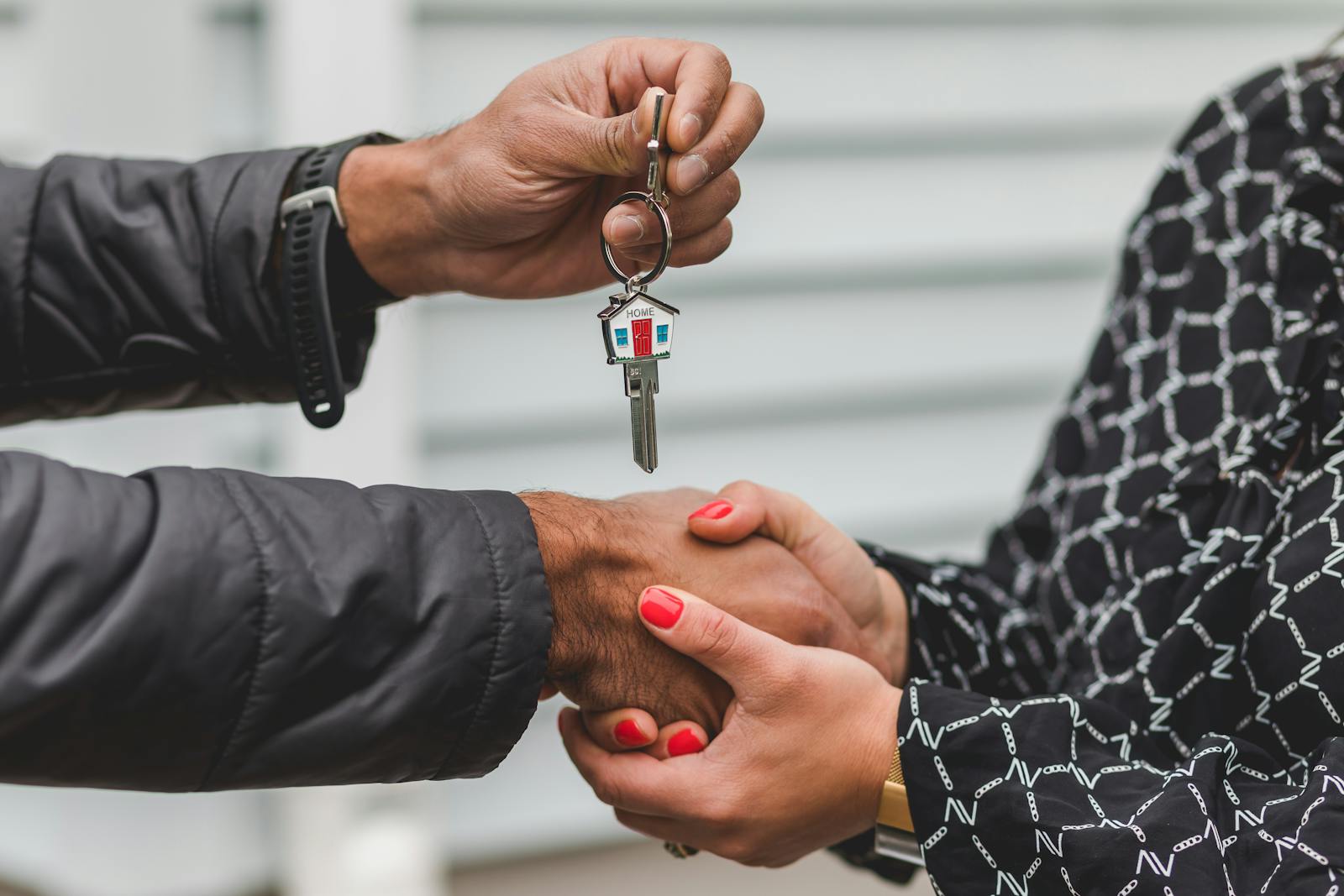 Real estate agent giving keys to customer