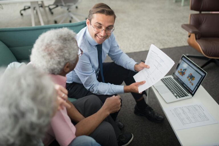 Trustee showing documents to elderly couple